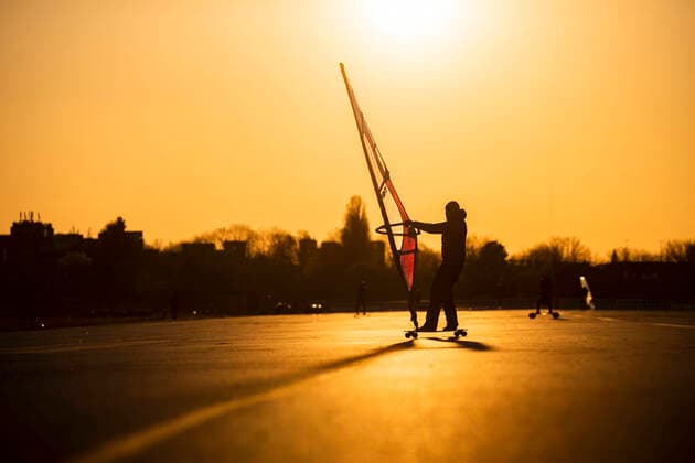 People practice kitelandboarding in the sun at Tempelhofer Feld in Berlin on 21 March 2020 The c