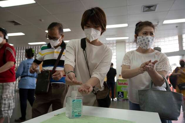 March 21, 2020, Bangkok, Thailand: Shoppers clean their hands with hand sanitizer gel in the entrance to a big box supermarket in Bangkok. After the Thai government s announcement of a partial shutdown in Bangkok which would close all businesses except supermarkets, pharmacies, and take-out restaurants shoppers filled supermarkets throughout the city to stock up on food and supplies in anticipation of a rumored complete lockdown of the city. Bangkok Thailand - ZUMAt128 20200321_zap_t128_015 Copyright: xAdryelxTalamantesx