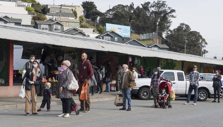 Shoppers at Farmers Market on Alemany Street practice social distancing while waiting in line for produce in San Francisco on Saturday, March 21, 2020. All of California is ordered to shelter in place.  SXP2020032104 TERRYxSCHMITT