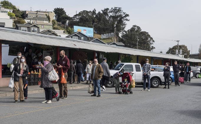 Shoppers at Farmers Market on Alemany Street practice social distancing while waiting in line for produce in San Francisco on Saturday, March 21, 2020. All of California is ordered to shelter in place.  SXP2020032105 TERRYxSCHMITT