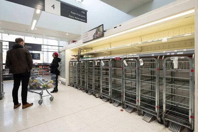 (200321) -- LONDON, March 21, 2020 (Xinhua) -- People stand by almost-empty shelves of a supermarket in London, Britain, March 21, 2020. As of 9a.m. (0900GMT) on Saturday, 72,818 people have been tested in Britain, of which 67,800 were confirmed negative and 5,018 were confirmed positive. 233 patients in the country who tested positive for the virus have died. (Xinhua) BRITAIN-LONDON-COVID-19