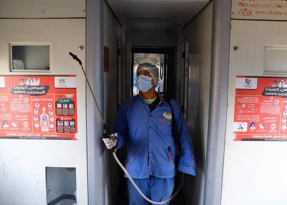 (200321) -- CAIRO, March 21, 2020 (Xinhua) -- A man sprays disinfectant in a train at Ramses railway station in Cairo, Egypt, on March 21, 2020. Egypt announced on Saturday two more deaths from COVID-19 and nine new cases of infection, bringing the total number of confirmed cases to 294 in the country. (Photo by Ahmed Gomaa Xinhua) EGYPT-CAIRO-COVID-19-MEASURES 
