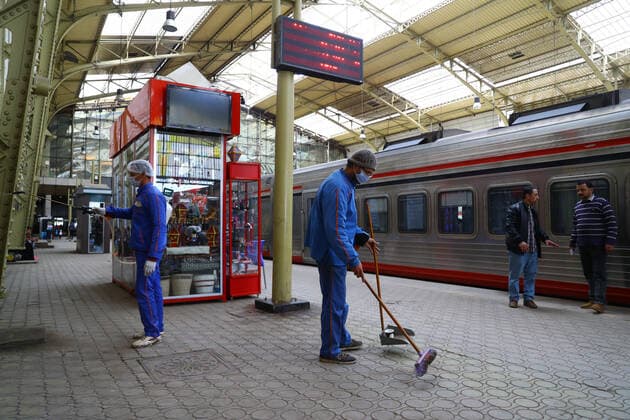 (200321) -- CAIRO, March 21, 2020 (Xinhua) -- A man (L) sprays disinfectant at Ramses railway station in Cairo, Egypt, on March 21, 2020. Egypt announced on Saturday two more deaths from COVID-19 and nine new cases of infection, bringing the total number of confirmed cases to 294 in the country. (Photo by Ahmed Gomaa Xinhua) EGYPT-CAIRO-COVID-19-MEASURES 