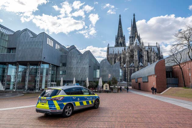 Effects of the coronavirus crisis, empty shopping street, police patrol car, Cologne Cathedral, Heinrich Böll Platz, in Cologne, Germany, corona crisis