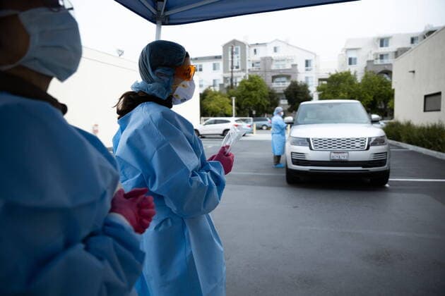 March 21, 2020, San Mateo, California, USA: CLARISSA NEWMAN holds a sample kit a safe distance from viral immunologist Dr Montoya as he takes samples for coronavirus testing. San Mateo USA - ZUMA 20200321_mda_h167_012 Copyright: xChrisxHardyx