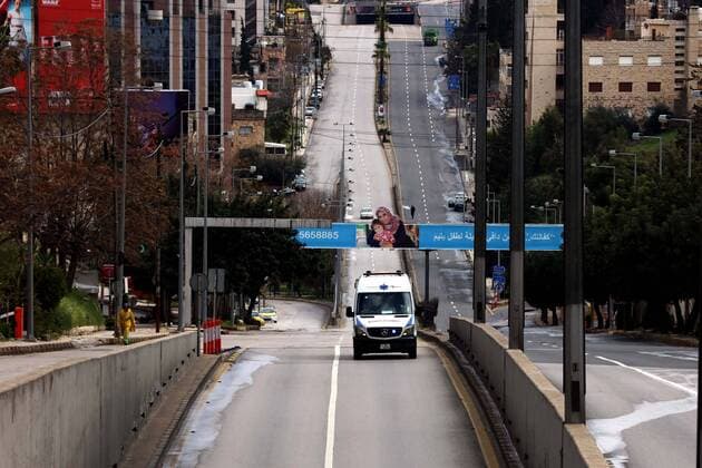 (200322) -- AMMAN, March 22, 2020 -- Ambulance is seen in an empty street after the start of the nationwide curfew in downtown Amman, Jordan, March 21, 2020. On March 21, Jordan started imposing a curfew as part of the measures to limit the spread of coronavirus. (Photo by Muhammad Abu Ghosh Xinhua) JORDAN-AMMAN-COVID-19-CURFEW MohammadxAbuxGhosh 