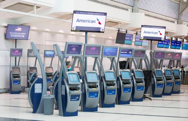 (200322) -- ONTARIO, March 22, 2020 -- The U.S. check-in express service area is seen with few people at the Terminal 3 of the Pearson International Airport in Toronto, Canada, March 21, 2020. At midnight on Friday the land border between Canada and the United States was closed to all non-essential travel in an effort to stem the spread of COVID-19. (Photo by Xinhua) CANADA-ONTARIO-COVID-19-U.S.-BORDER-CLOSURE ZouxZheng 