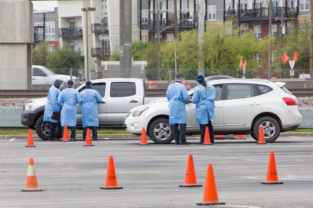 (200322) -- DALLAS, March 22, 2020 (Xinhua) -- Staff work at a drive-through COVID-19 testing site in Dallas, Texas, the United States, March 21, 2020. The number of COVID-19 cases in the United States topped 20,000 as of 1:30 p.m. Eastern Standard Time on Saturday (1730 GMT), according to the Center for Systems Science and Engineering (CSSE) at Johns Hopkins University. (Photo by Dan Tian Xinhua) U.S.-TEXAS-DALLAS-COVID-19-TESTING SITES 