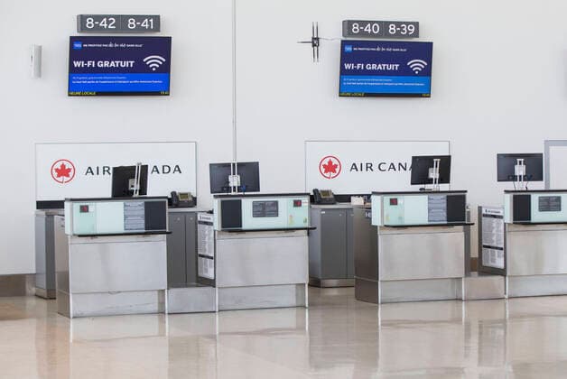 (200322) -- TORONTO, March 22, 2020 -- Check-in counters of Air Canada are seen at the Terminal 1 of Pearson International Airport in Toronto, Canada, March 21, 2020. Air Canada is laying off more than 5,000 flight attendants as the country s largest airline cuts routes and parks planes due to the COVID-19 pandemic. The temporary layoffs will take effect by April. (Photo by Xinhua) CANADA-TORONTO-COVID-19-AIR CANADA-LAY OFF ZouxZheng 