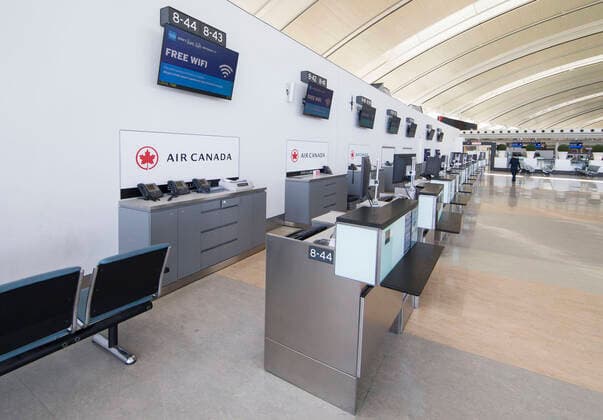 (200322) -- TORONTO, March 22, 2020 -- Closed check-in counters of Air Canada are seen at the Terminal 1 of Pearson International Airport in Toronto, Canada, March 21, 2020. Air Canada is laying off more than 5,000 flight attendants as the country s largest airline cuts routes and parks planes due to the COVID-19 pandemic. The temporary layoffs will take effect by April. (Photo by Xinhua) CANADA-TORONTO-COVID-19-AIR CANADA-LAY OFF ZouxZheng 