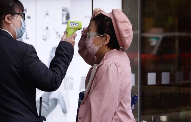 March 22, 2020, Hong Kong, CHINA: A visitor receiving thermo check outside a hotel before entering the arcade.Mar-22,2020 Hong Kong.ZUMA Hong Kong CHINA - ZUMAl137 20200322_zap_l137_001 Copyright: xLiauxChung-renx