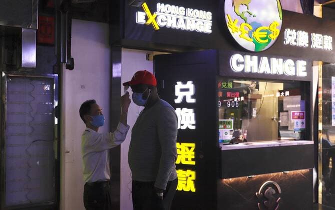 March 22, 2020, Hong Kong, CHINA: A foreigner receive thermo check by the security guard at the local shopping arcade before entering the premise.Mar-22,2020 Hong Kong.ZUMA Hong Kong CHINA - ZUMAl137 20200322_zap_l137_002 Copyright: xLiauxChung-renx