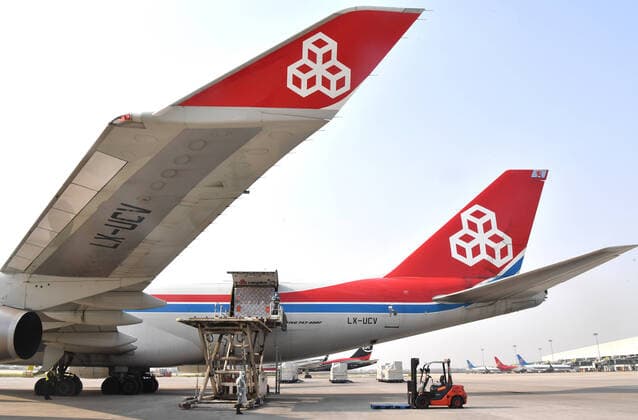 (200322) -- ZHENGZHOU, March 22, 2020 -- Staff load donated materials onto a cargo plane at Xinzheng International Airport in Zhengzhou, capital of central China s Henan Province, March 22, 2020. The first batch of medical supplies donated by China s Henan Province, including 500,000 surgical masks and 100,000 pairs of medical gloves, departed from Zhengzhou on Sunday for Luxembourg by direct airline along the Air Silk Road linking Luxembourg with Zhengzhou to help Luxembourg fight the COVID-19. ) CHINA-HENAN-COVID-19-LUXEMBOURG-DONATED MATERIALS-DEPARTURE (CN) LixJianan 