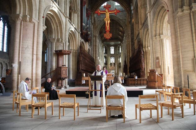 The Mothering Sunday service at Peterborough Cathedral goes ahead without a congregation as it is live streamed across the internet for people to watch wherever they can. The COVID-19 Coronavirus pandemic crisis continues, with cafes, bars, restaurants, gyms and leisure centres forced to close, as well as places of worship like churches, cathedrals, mosques and synagogues. COVID-19 Coronavirus crisis, Peterborough, Cambridgeshire, UK, on March 22, 2020 