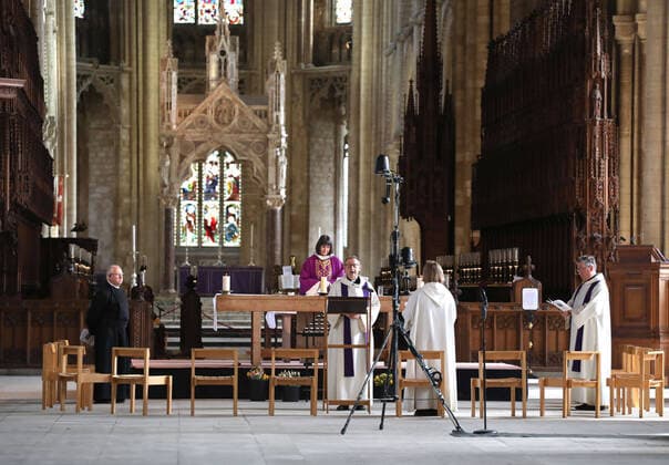 The Mothering Sunday service at Peterborough Cathedral goes ahead without a congregation as it is live streamed across the internet for people to watch wherever they can. The COVID-19 Coronavirus pandemic crisis continues, with cafes, bars, restaurants, gyms and leisure centres forced to close, as well as places of worship like churches, cathedrals, mosques and synagogues. COVID-19 Coronavirus crisis, Peterborough, Cambridgeshire, UK, on March 22, 2020 