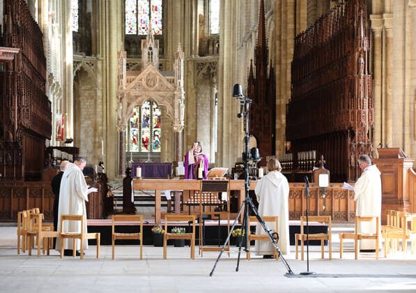 The Mothering Sunday service at Peterborough Cathedral goes ahead without a congregation as it is live streamed across the internet for people to watch wherever they can. The COVID-19 Coronavirus pandemic crisis continues, with cafes, bars, restaurants, gyms and leisure centres forced to close, as well as places of worship like churches, cathedrals, mosques and synagogues. COVID-19 Coronavirus crisis, Peterborough, Cambridgeshire, UK, on March 22, 2020 