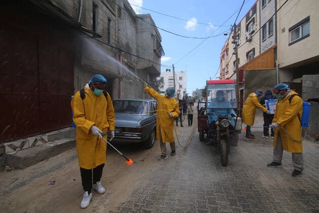 (200322) -- GAZA, March 22, 2020 -- Palestinian workers sterilize a street in the southern Gaza Strip city of Rafah, March 22, 2020. Two Palestinians in Gaza have tested positive for COVID-19, becoming the first cases recorded in the Hamas-ruled enclave, a health official said early Sunday. A total of 53 Palestinians have been infected with the virus since March 5, and 17 of them have recovered, the health ministry in the West Bank said earlier Saturday. (Photo by Khaled Omar Xinhua) MIDEAST-GAZA-COVID-19 xiongsihao 