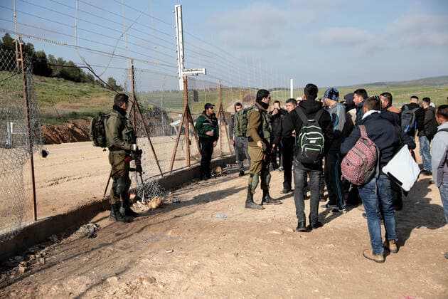 (200322) -- HEBRON, March 22, 2020 -- Palestinian workers try to enter Israel through a checkpoint between the West Bank city of Hebron and Beersheva, March 22, 2020. The Israeli authorities announced late on Saturday that all crossings to and from Israel will be closed to limit the spread of COVID-19. A total of 53 Palestinians have been infected with the virus since March 5, and 17 of them have recovered, the health ministry in the West Bank said earlier Saturday. (Photo by Mamoun Wazwaz Xinhua) MIDEAST-HEBRON-CROSSING POINTS-CLOSURE-WORKERS xiongsihao 