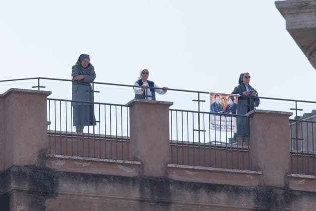 Rome: Pope Francis at window in days of Covid-19 Nuns wait Pope Francis Pope Francis after the recitation of the Angelus prayer in live streaming from the Library of the Vatican Apostolic Palace looks out the window observing St. Peter s Square empty of people, on the morning of Sunday 22 March 2020 Roma Italy Copyright: MatteoxNardone