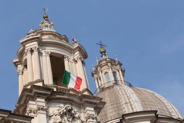 Rome: Italian flag on church in days of COVID-19 Italian flags on the Church of Sant Agnese in Agone and on some balconies in a Piazza Navona without people, on the morning of Sunday 22 March 2020, during the Covid-19 pandemic Roma Italy Copyright: MatteoxNardone