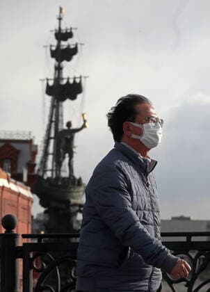 MOSCOW, RUSSIA - MARCH 22, 2020: A man wearing a face mask amid the ongoing COVID-19 pandemic, against the background of Peter the Great Statue. Artyom Geodakyan TASS  TS0D30E3