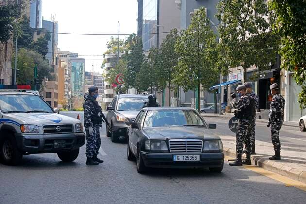 (200322) -- BEIRUT, March 22, 2020 (Xinhua) -- Members of security forces check a car on a road in Beirut, Lebanon, March 22, 2020. Lebanon s number of COVID-19 infected cases increased on Sunday by 18 to 248, the National News Agency reported. Lebanon deployed on Sunday security forces all over the country to prevent people from leaving their houses in an attempt to restrict the spread of COVID-19. (Photo by Bilal Jawich Xinhua) LEBANON-BEIRUT-COVID-19-MEASURES 