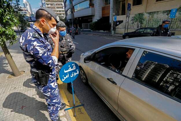 (200322) -- BEIRUT, March 22, 2020 (Xinhua) -- Members of security forces check a driver on a road in Beirut, Lebanon, March 22, 2020. Lebanon s number of COVID-19 infected cases increased on Sunday by 18 to 248, the National News Agency reported. Lebanon deployed on Sunday security forces all over the country to prevent people from leaving their houses in an attempt to restrict the spread of COVID-19. (Photo by Bilal Jawich Xinhua) LEBANON-BEIRUT-COVID-19-MEASURES 