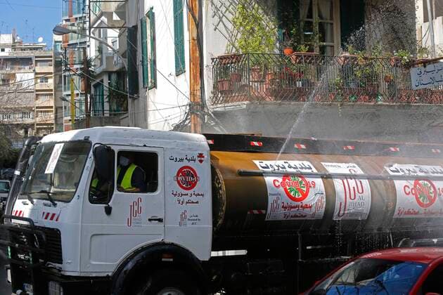(200322) -- BEIRUT, March 22, 2020 (Xinhua) -- A sanitation vehicle sterilizes a street in Beirut, Lebanon, March 22, 2020. Lebanon s number of COVID-19 infected cases increased on Sunday by 18 to 248, the National News Agency reported. Lebanon deployed on Sunday security forces all over the country to prevent people from leaving their houses in an attempt to restrict the spread of COVID-19. (Photo by Bilal Jawich Xinhua) LEBANON-BEIRUT-COVID-19-MEASURES 
