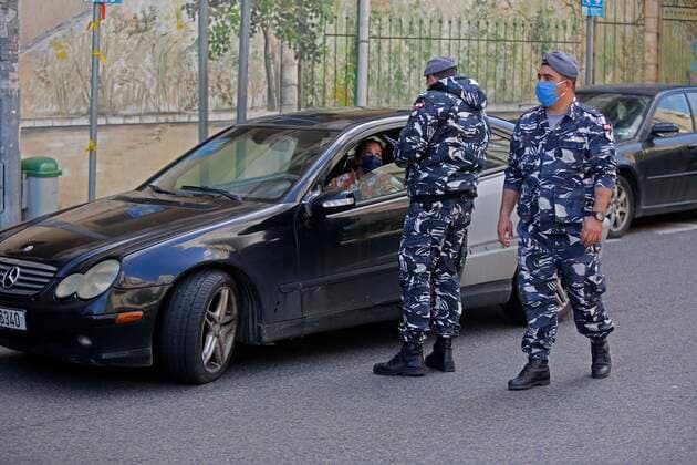 (200322) -- BEIRUT, March 22, 2020 (Xinhua) -- Members of security forces check a driver on a road in Beirut, Lebanon, March 22, 2020. Lebanon s number of COVID-19 infected cases increased on Sunday by 18 to 248, the National News Agency reported. Lebanon deployed on Sunday security forces all over the country to prevent people from leaving their houses in an attempt to restrict the spread of COVID-19. (Photo by Bilal Jawich Xinhua) LEBANON-BEIRUT-COVID-19-MEASURES 