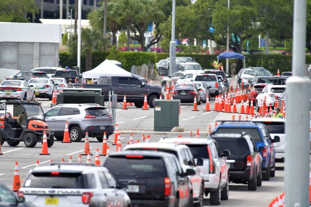 March 23, 2020, Miami Gardens, Florida, United States Of America: MIAMI GARDENS, FL - MARCH 22: FIRST RESPONDERS ONLY TESTING DAY - Instead of setting up for the Miami Open tennis tournament, the Florida National Guard (many without face masks due to shortage) was running a drive-through testing site off the Florida Turnpike at the Hard Rock Stadium in Miami Gardens where people can go for a COVID-19 Test Without Getting out of their Cars. As Miami-Dade Countys number of COVID-19 cases rise to 169, the site will open at 9 a.m. Monday in the east parking lot of the Hard Rock Stadium, 347 Don Shula Drive. The testing is free and the site will be open from 9 a.m. to 5 p.m. on a daily basis, said Juan Diasgranados, a spokesperson for the testing site. The test site will be run and was created by several local, state and national agencies wh - ZUMAs214 20200323_zaa_s214_029 Copyright: xSMGx