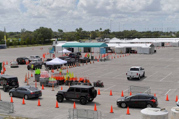 MIAMI GARDENS, FL - MARCH 22: FIRST RESPONDERS ONLY TESTING DAY - Instead of setting up for the Miami Open tennis tournament, the Florida National Guard (many without face masks due to shortage) was running a drive-through testing site off the Florida Turnpike at the Hard Rock Stadium in Miami Gardens where people can go for a COVID-19 Test Without Getting out of their Cars. As Miami-Dade Countys number of COVID-19 cases rise to 169, the site will open at 9 a.m. Monday in the east parking lot of the Hard Rock Stadium, 347 Don Shula Drive. The testing is free and the site will be open from 9 a.m. to 5 p.m. on a daily basis, said Juan Diasgranados, a spokesperson for the testing site. The test site will be run and was created by several local, state and national agencies which include FEMA, the CDC, Florida Department of Health, Florida A - ZUMAs214 20200323_zba_s214_020 Copyright: xSMGx