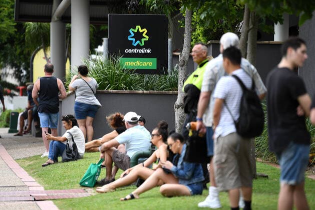 CENTRELINK QUEUES GOLD COAST, People are seen in long queues outside the Centrelink office in Southport on the Gold Coast, Monday, March 23, 2020. Centrelink offices around Australia have been inundated with people attempting to register for the Jobseeker allowance in the wake of business closures due to the COVID-19 pandemic. ( NO ARCHIVING, EDITORIAL USE ONLY, NO USE IN BOOKS WITHOUT CONSENT GOLD COAST QLD AUSTRALIA  Copyright: xDANxPELEDx 20200323001458858716