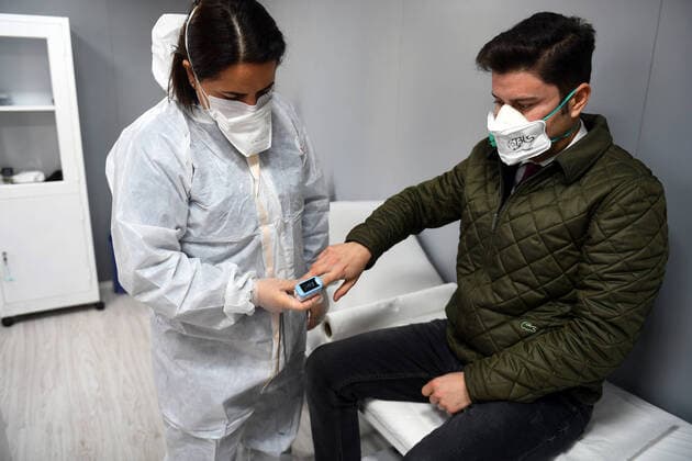 (200323) -- ANKARA, March 23, 2020 -- A medical worker checks a citizen s health at a temporary clinic for COVID-19 testing in downtown Ankara, Turkey, on March 22, 2020. The death toll from COVID-19 in Turkey rose to 30 on Sunday, Turkish Health Minister Fahrettin Koca said. The minister tweeted that nine people lost their lives on Sunday, and 289 new patients were diagnosed, bringing the total number of confirmed cases to 1,236. (Photo by Mustafa Kaya Xinhua) TURKEY-ANKARA-COVID-19-TEMPORARY CLINIC zhengsiyuan 