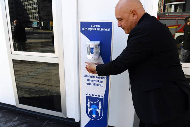 (200323) -- ANKARA, March 23, 2020 -- A citizen disinfects his hands outside a temporary clinic for COVID-19 testing in downtown Ankara, Turkey, on March 22, 2020. The death toll from COVID-19 in Turkey rose to 30 on Sunday, Turkish Health Minister Fahrettin Koca said. The minister tweeted that nine people lost their lives on Sunday, and 289 new patients were diagnosed, bringing the total number of confirmed cases to 1,236. (Photo by Mustafa Kaya Xinhua) TURKEY-ANKARA-COVID-19-TEMPORARY CLINIC zhengsiyuan 