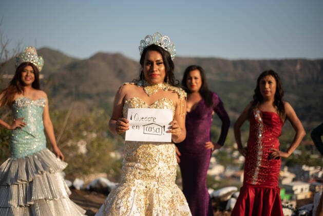 March 22, 2020, Jalcomulco, Veracruz, Mo xico: Members of the LGBTTI court of the Jalcomulco carnival carry out an awareness and prevention campaign of COVID-19. The royal court is made up of a queen and princesses who dance and celebrate during the carnival through the streets of the town. This year, the party and carnival have been canceled to prevent some kind of contagion among the population, however, the court does not miss the opportunity to send a message to the residents to wash their hands and avoid leaving home. In the image, the carnival LGBTTI Queen holds a sign that says: Stay at home Jalcomulco MÃ xico - ZUMAqp1_ 20200322_zip_qp1_013 Copyright: xHectorxAdolfoxQuintanarxPerezx