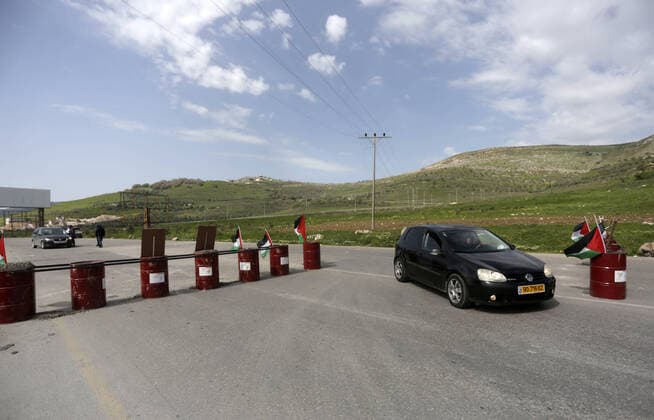 March 23, 2020, Nablus, West Bank, Palestinian Territory: Palestinian policemen stand at the streets during of a mandatory quarantine that was announced by the Palestinian Authority as part of measures against the COVID-19 coronavirus pandemic, in the West Bank city of Nablus on March 23, 2020. The Palestinian Health Ministry today reported its first two cases of the novel coronavirus in the Gaza Strip. undertook serious measures to preempt the arrival of the virus to the strip. Up until its decision to seal off its sides of the Rafah crossing with Egypt and the Erez checkpoint with Israel, hundreds of Palestinians who entered the strip were immediately quarantined to ensure they had no symptoms of the disease Nablus Palestinian Territory - ZUMAap3_ 20200323_zaf_ap3_067 Copyright: xShadixJarar Ahx