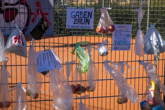 To help the needy and homeless, residents of the Leipzig district of Connewitz hung bags of food, toiletries, clothing, pet food and other groceries on the fence of a basketball court