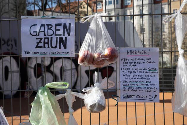 To help the needy and homeless, residents of the Leipzig district of Connewitz hung bags of food, toiletries, clothing, pet food and other groceries on the fence of a basketball court