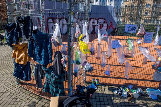 To help the needy and homeless, residents of the Leipzig district of Connewitz hung bags of food, toiletries, clothing, pet food and other groceries on the fence of a basketball court