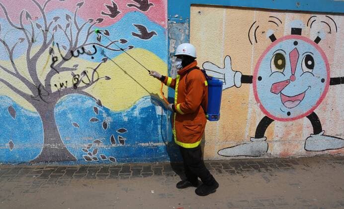 March 23, 2020, Khan Younis, Gaza Strip, Palestinian Territory: Palestinian Members of the Civil Defense disinfect the streets, as a preventive measure amid fears of the spread of the coronavirus, in Khan Younis in the southern of Gaza strip, on March 23, 2020. The Palestinian Health Ministry today reported its first two cases of the novel coronavirus in the Gaza Strip. undertook serious measures to preempt the arrival of the virus to the strip. Up until its decision to seal off its sides of the Rafah crossing with Egypt and the Erez checkpoint with Israel, hundreds of Palestinians who entered the strip were immediately quarantined to ensure they had no symptoms of the disease Khan Younis Palestinian Territory - ZUMAap3_ 20200323_zaf_ap3_101 Copyright: xAshrafxAmrax