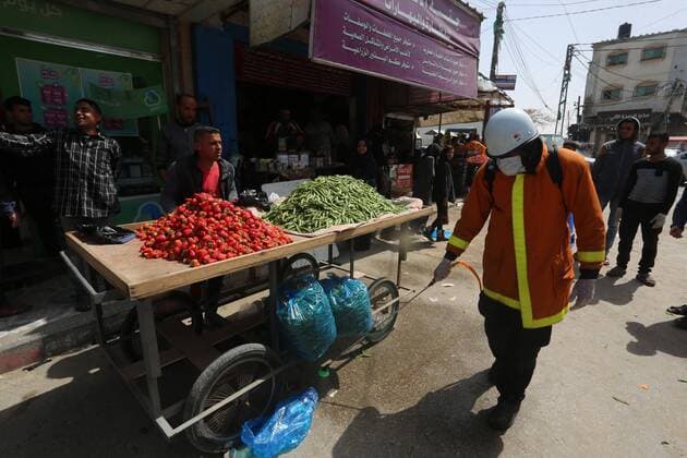 March 23, 2020, Khan Younis, Gaza Strip, Palestinian Territory: Palestinian Members of the Civil Defense disinfect the streets, as a preventive measure amid fears of the spread of the coronavirus, in Khan Younis in the southern of Gaza strip, on March 23, 2020. The Palestinian Health Ministry today reported its first two cases of the novel coronavirus in the Gaza Strip. undertook serious measures to preempt the arrival of the virus to the strip. Up until its decision to seal off its sides of the Rafah crossing with Egypt and the Erez checkpoint with Israel, hundreds of Palestinians who entered the strip were immediately quarantined to ensure they had no symptoms of the disease Khan Younis Palestinian Territory - ZUMAap3_ 20200323_zaf_ap3_109 Copyright: xAshrafxAmrax