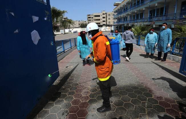 March 23, 2020, Khan Younis, Gaza Strip, Palestinian Territory: Palestinian Members of the Civil Defense disinfect the streets, as a preventive measure amid fears of the spread of the coronavirus, in Khan Younis in the southern of Gaza strip, on March 23, 2020. The Palestinian Health Ministry today reported its first two cases of the novel coronavirus in the Gaza Strip. undertook serious measures to preempt the arrival of the virus to the strip. Up until its decision to seal off its sides of the Rafah crossing with Egypt and the Erez checkpoint with Israel, hundreds of Palestinians who entered the strip were immediately quarantined to ensure they had no symptoms of the disease Khan Younis Palestinian Territory - ZUMAap3_ 20200323_zaf_ap3_115 Copyright: xAshrafxAmrax
