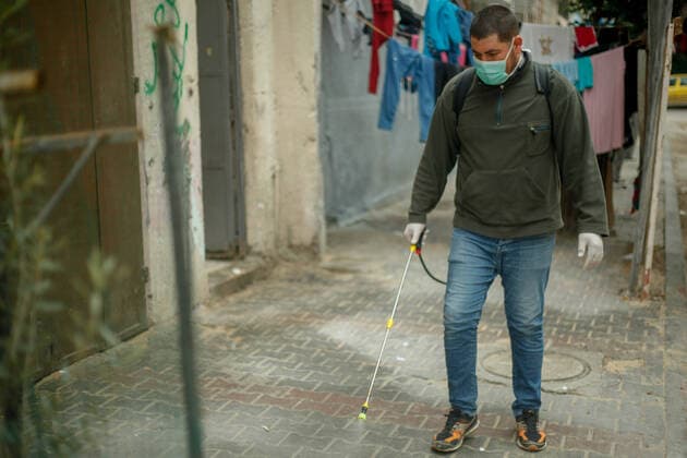 Coronavirus precautions in Gaza A member of a volunteer group carries out disinfection works as a precaution against the coronavirus (COVID-19) pandemic at a shopping area in Beit Lahia, north of Gaza, Gaza. Gaza Palestine Copyright: RamezxHabboub