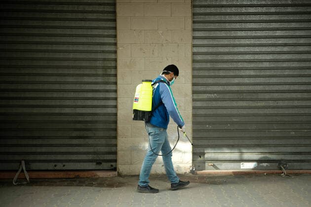 Coronavirus precautions in Gaza A member of a volunteer group carries out disinfection works as a precaution against the coronavirus (COVID-19) pandemic at a shopping area in Beit Lahia, north of Gaza, Gaza. Gaza Palestine Copyright: RamezxHabboub