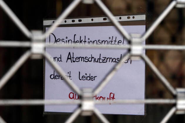 Poster with inscription Disinfectants and respirators sold out at a closed pharmacy in the city center of Mannheim, Baden Württemberg, Germany