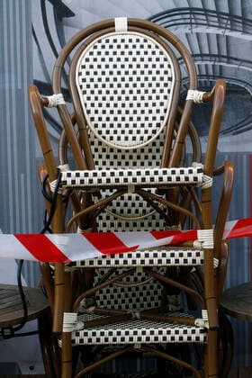 Chairs of a closed café in the city centre of Mannheim, Baden Württemberg, Germany