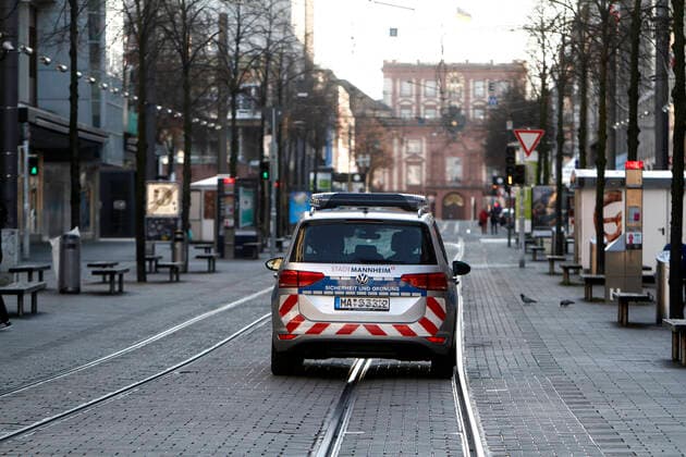 Due to the official decree to close all shops and to stop public life as far as possible, the shopping street and pedestrian zone Planken in downtown Mannheim, which is otherwise always very busy with passers-by, is largely deserted, Baden Württemberg, Germany A police patrol of the city police checks the implementation of the regulations in an emergency vehicle