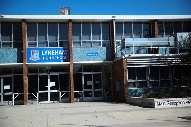 (200323) -- CANBERRA, March 23, 2020 -- Photo taken on March 23, 2020 shows Lyneham High School that is shut down after a student was found infected with novel coronavirus in Canberra, Australia. Non-essential venues across Australia have been ordered to close from midday on Monday in order to slow the spread of COVID-19. Prime Minister Scott Morrison on Sunday night announced an escalation of social distancing measures, including the mandatory closure of cinemas, pubs, entertainment venues, indoor sporting venues and so on. Restaurants and cafes will remain open but will only be allowed to offer takeaway and or home delivery services. (Photo by Xinhua) AUSTRALIA-CANBERRA-COVID-19-SOCIAL DISTANCING MEASURES ChuxChen 