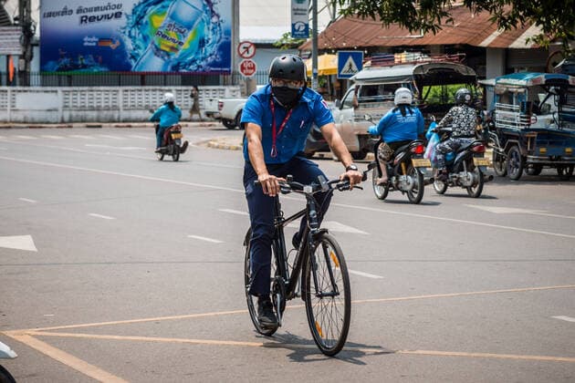 (200323) -- VIENTIANE, March 23, 2020 -- A man wearing face mask rides a bike on the street in Vientiane, Laos, March 23, 2020. Lao people have taken preventive measures against the COVID-19, despite there being no confirmed case of the virus infection in Laos. (Photo by Kaikeo Saiyasane Xinhua) LAOS-VIENTIANE-COVID19-DAILY LIFE ZhangxJianhua 