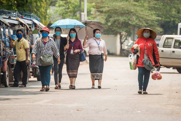 (200323) -- VIENTIANE, March 23, 2020 -- People wearing face masks are seen on the street in Vientiane, Laos, March 23, 2020. Lao people have taken preventive measures against the COVID-19, despite there being no confirmed case of the virus infection in Laos. (Photo by Kaikeo Saiyasane Xinhua) LAOS-VIENTIANE-COVID19-DAILY LIFE ZhangxJianhua 